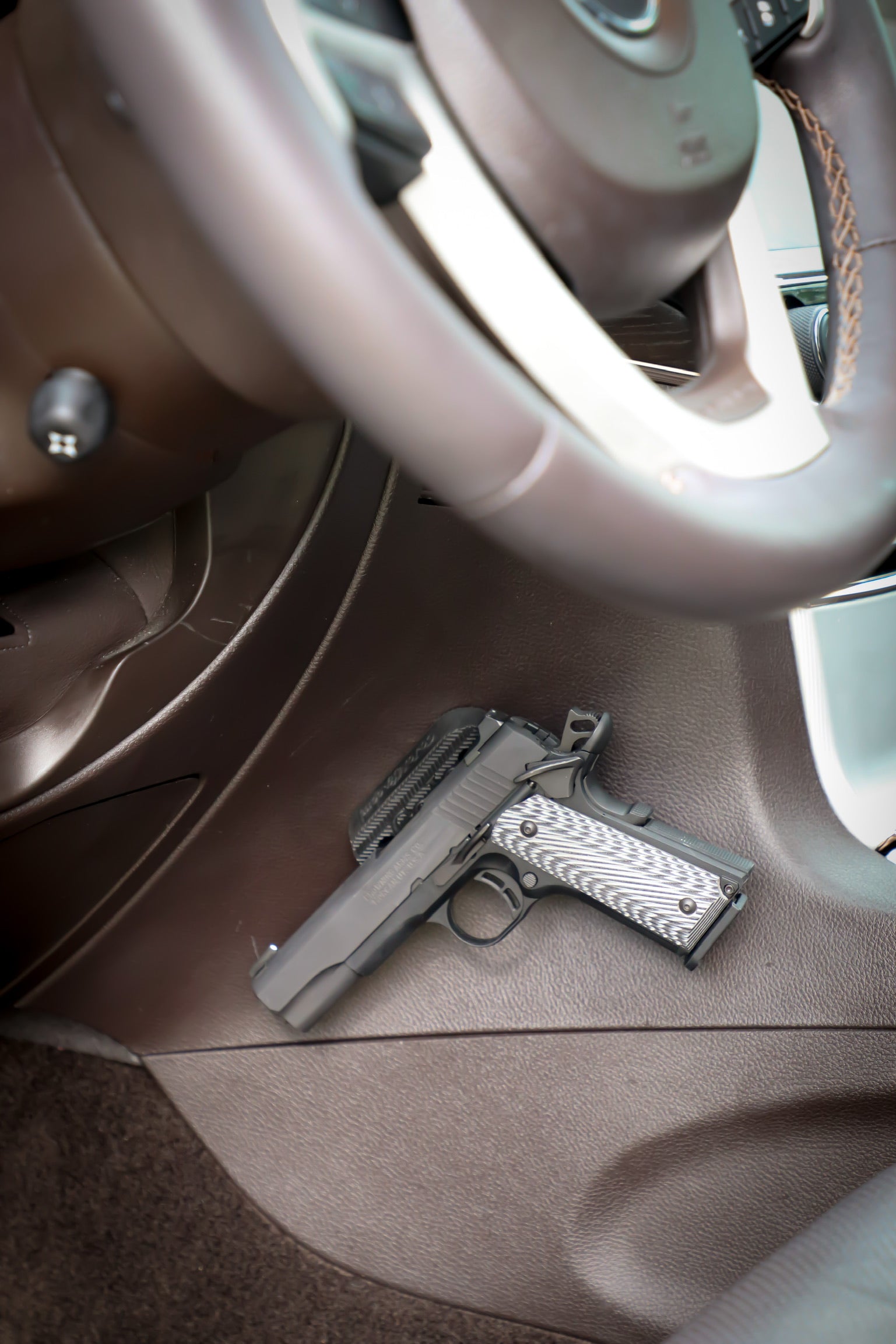 A Browning 1911 mounted under the dash of a Jeep Grand Cherokee with the CoJo Gun Gripper